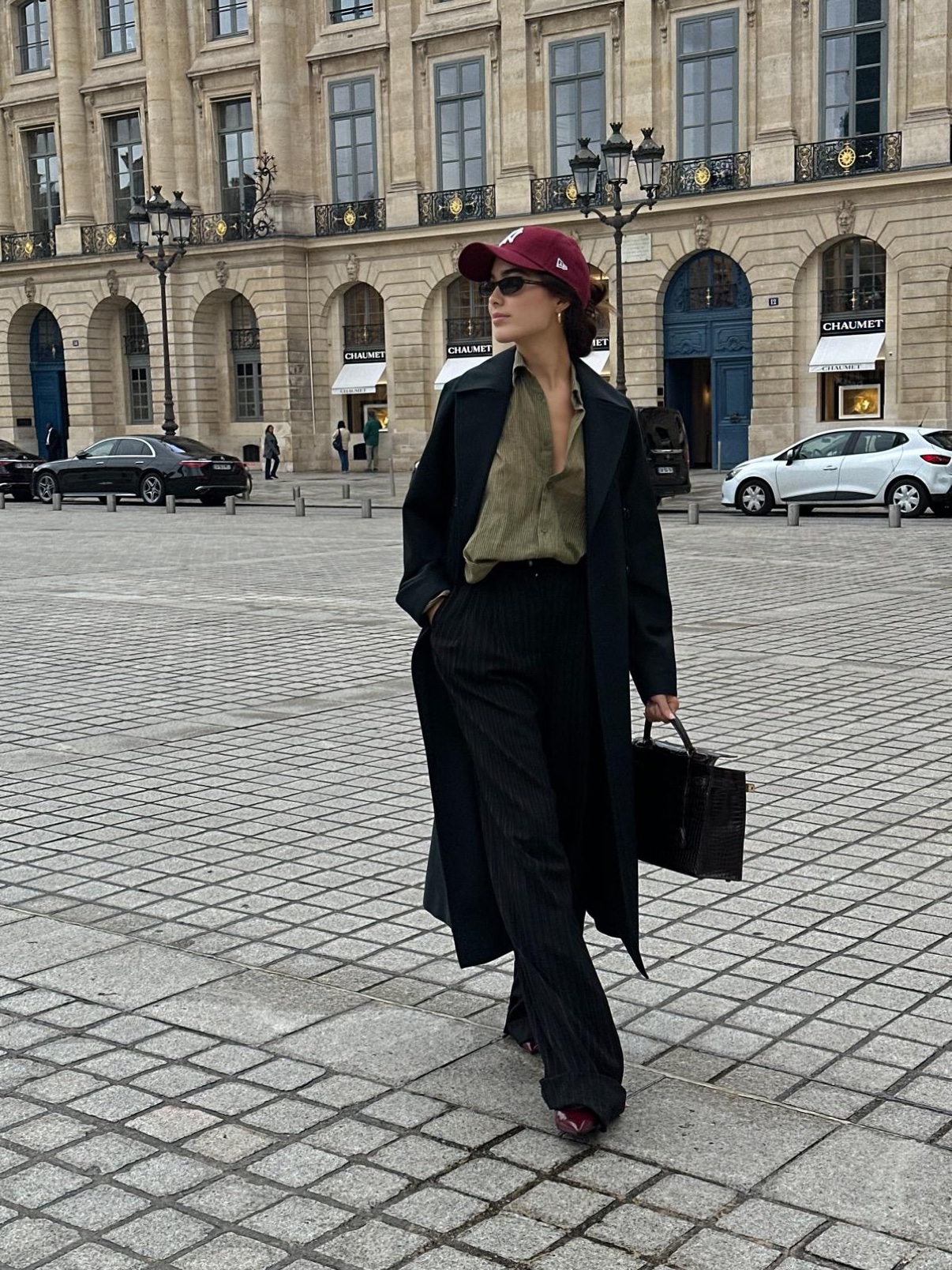 Sharon in a black coat and burgundy cap at Place Vendôme