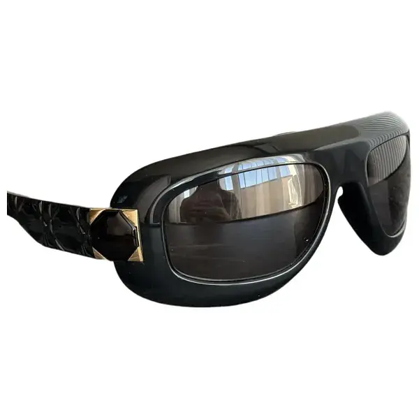 Black Dior sunglasses with a wide frame and dark lenses.