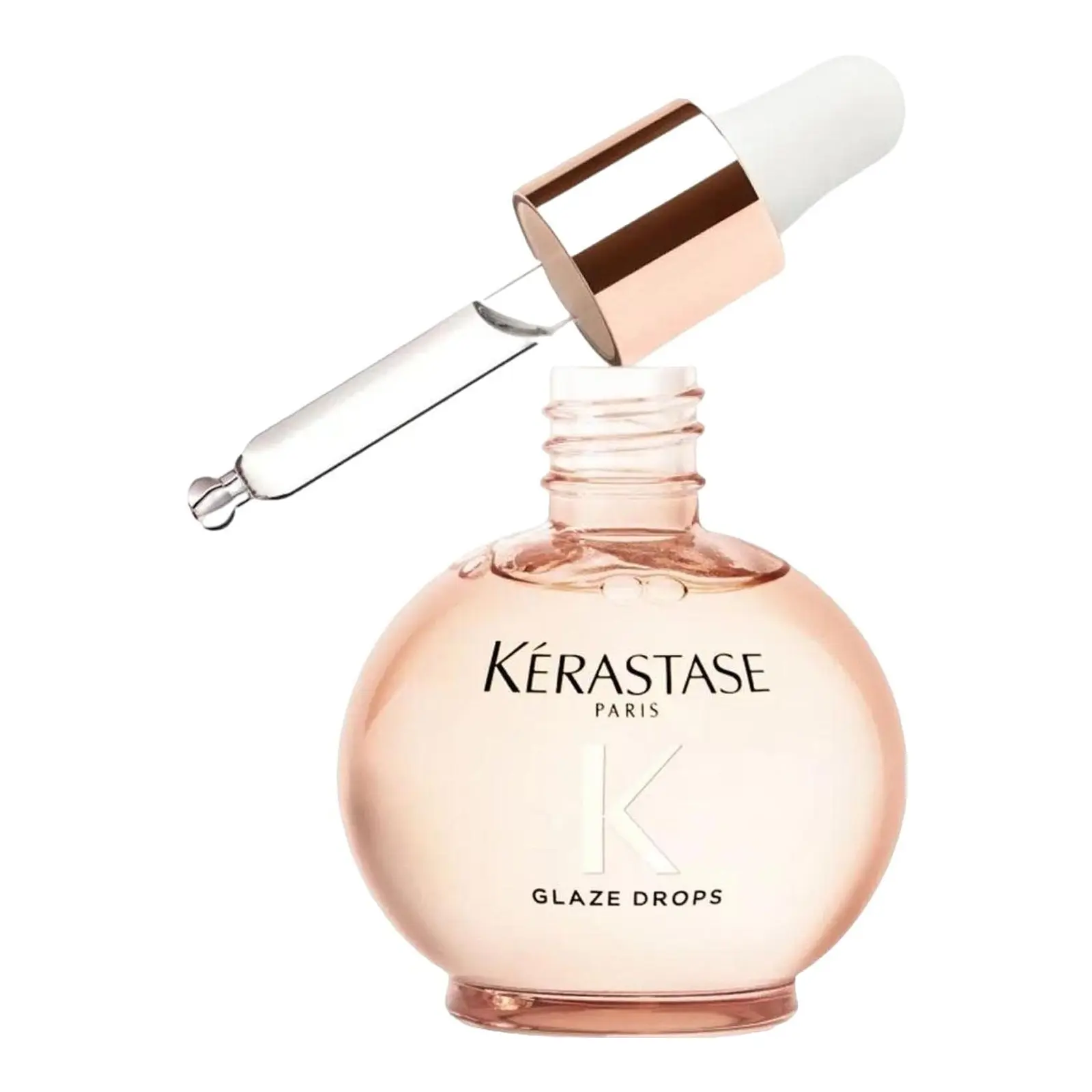 Pink Kérastase Glaze Drops hair oil bottle with a white and rose-gold dropper above it.